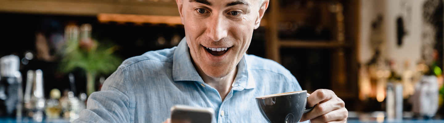 FECA - CS - Loan Payemnts self-employed-man-using-smartphone-reading-news