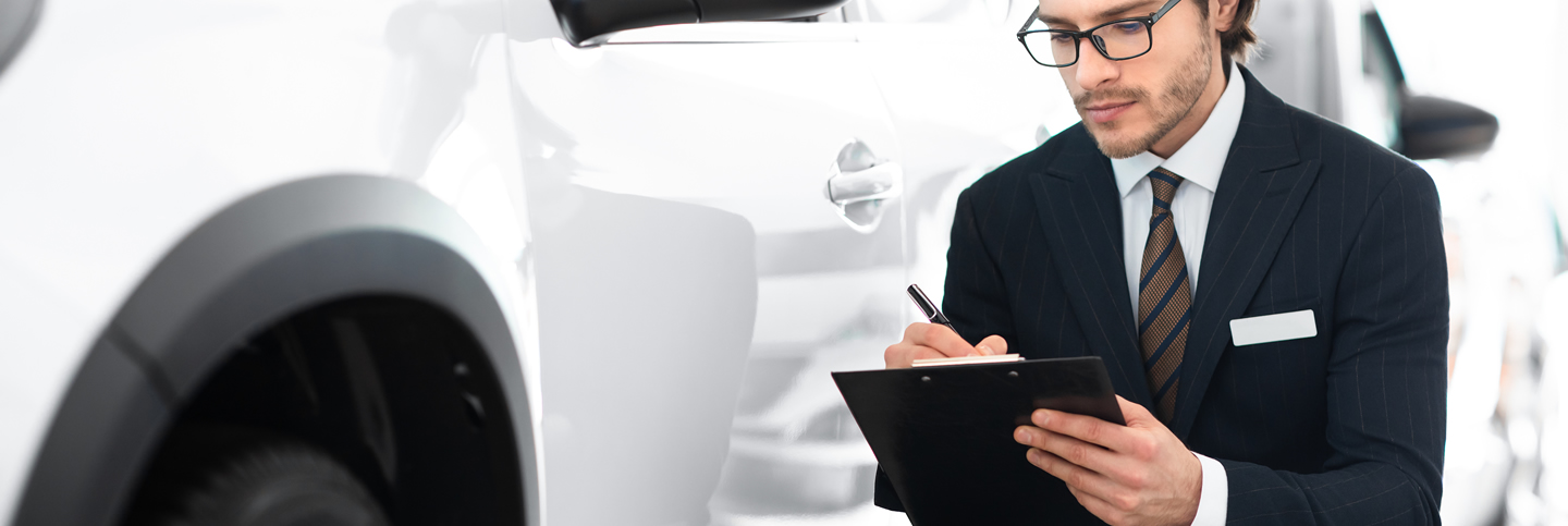 FECA - Loans - Auto Insurance insurance-agent-sitting-taking-notes-working