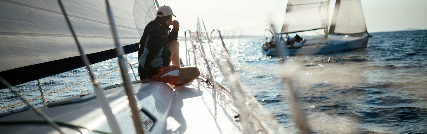 FECA -Loans - Boat young-handsome-man-relaxing-on-his-sailboat