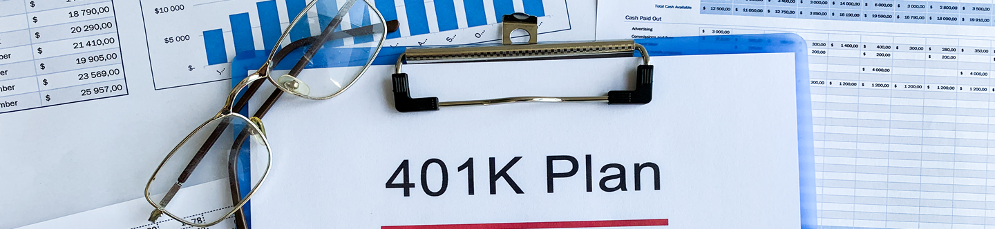 FECA - Loans - IRA paper-with-401k-plan-on-wood-table
