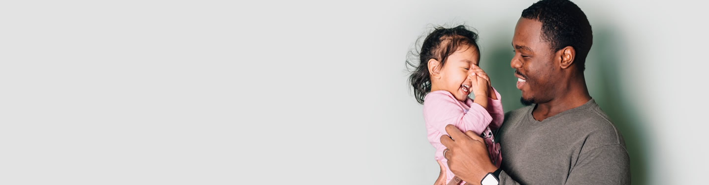 FECA Life Stages black-father-and-mixed-race-daughter-at-home-having 2